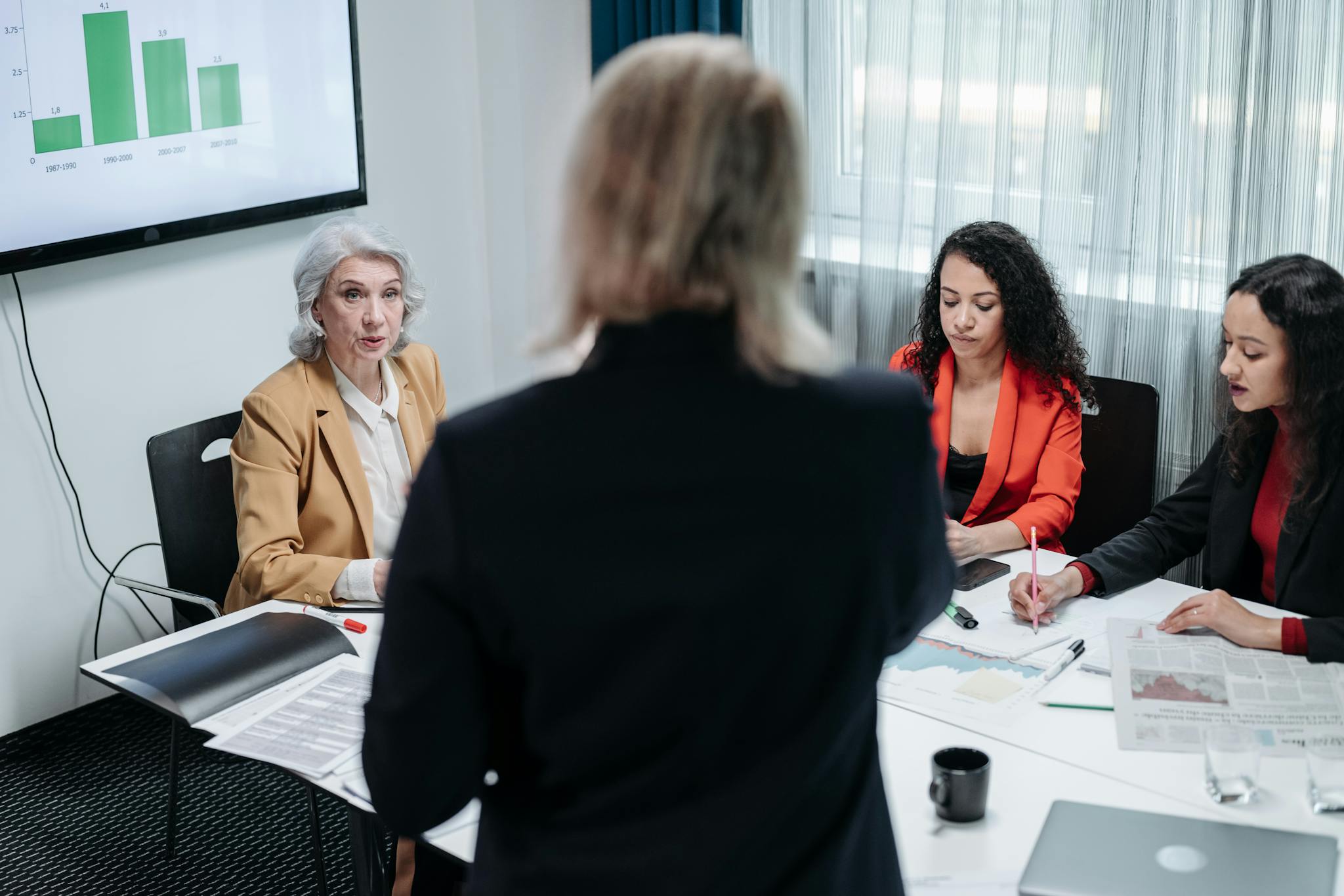 Team of professionals discussing strategy in a modern office setting during a business meeting.